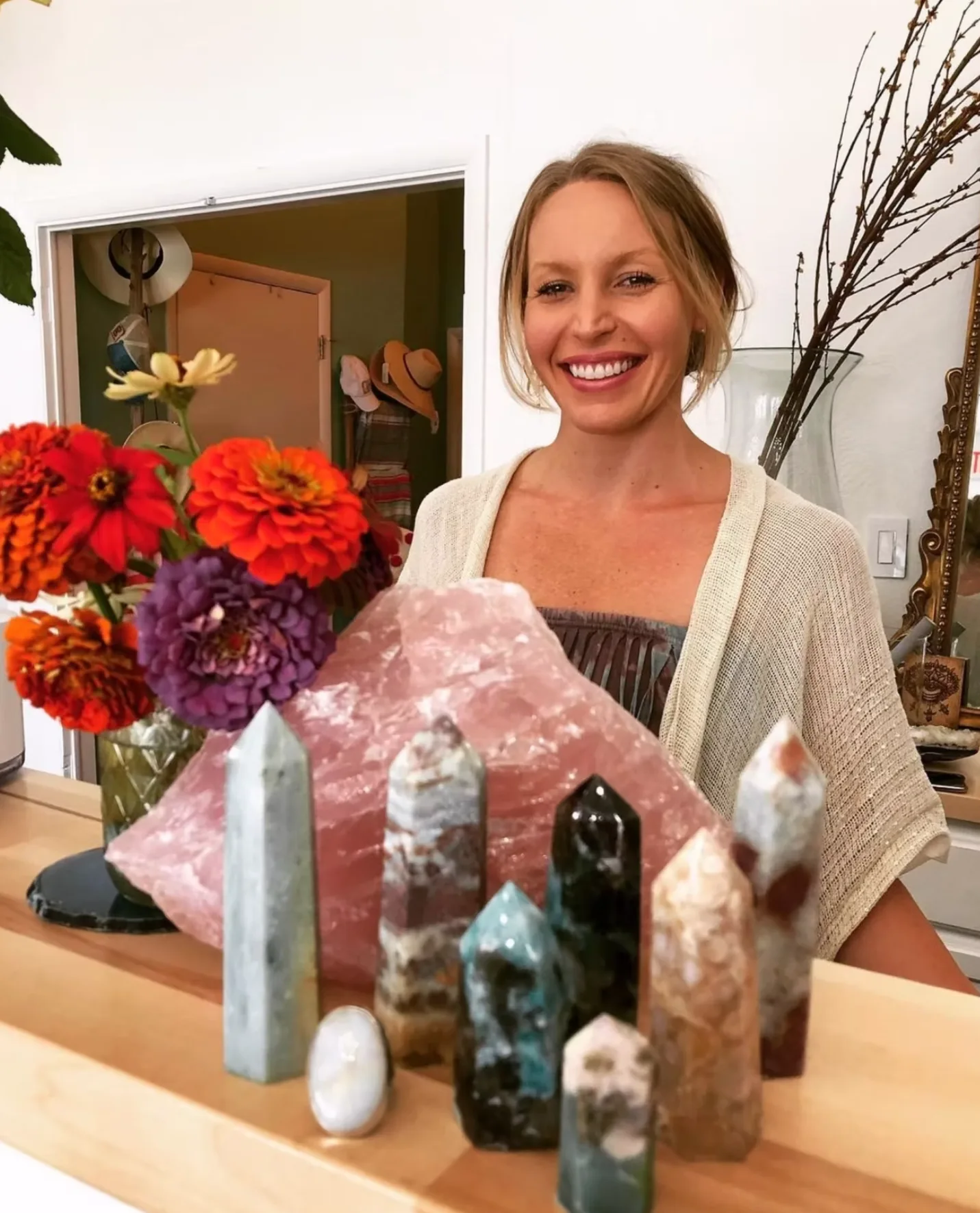 Taylor welcoming visitors inside Southern Crystal Company, home to Village Yoga